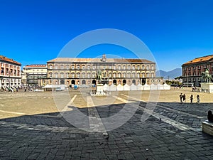 Monumental Plebiscite Square in Naples, Italy, with historic buildings and the outline of the Vesevius volcano