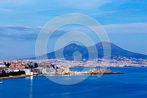 Naples by night, Vesuvius and Castel dell`Ovo, blue sky and sea