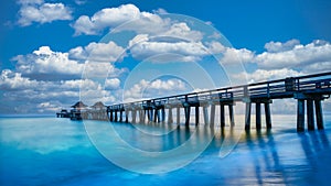 Naples Pier on the beach at sunset in Naples, Florida, USA