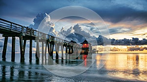 Naples Pier on the beach at sunset in Naples, Florida, USA