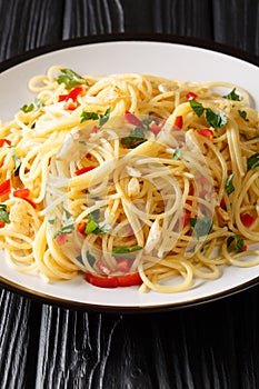 Naples traditional Aglio e Olio spaghetti close-up in a plate. Vertical