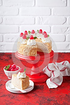 Napoleon cake with custard, decorated with raspberries