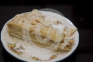 Napoleon cake on a fine ceramic plate