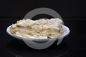 Napoleon cake on a fine ceramic plate