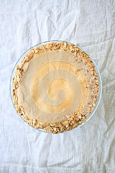 napoleon cake, round whole with caramel cream on a white background. copy space