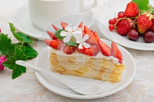 Napoleon cake with strawberries. Wooden background. Close-up. Top view