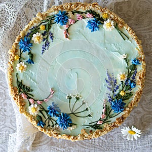 Napoleon cake with vanilla cream, decorated with buttercream flowers - summer wild flowers. Vintage style. Grey
