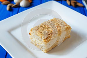 Napoleon or millefeuille cake close up sliced on square plate