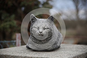 a napping purring cat statue