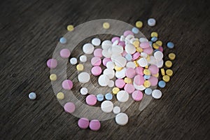Narcotic psychotropic substances pills on a wooden table photo