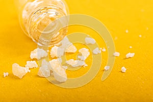 Narcotic salt crystals amphetamine on yellow background