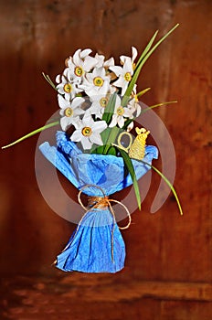 The narcysts are collected in a spring bouquet. Color paper decoration