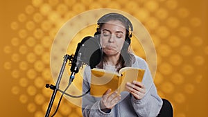 Narrator reading from book into mic, exhaling after finally finishing job