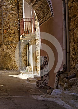 Narrow alley with decorated faucet sink, in Pyrgi  medieval village, Chios island, Greece