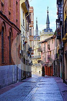 Narrow alley with old buildings and Leon town hall in the background, Spain. photo