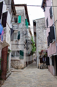 Narrow alley between old croatian houses in the picturesque old town of Rovinj, in Croatia