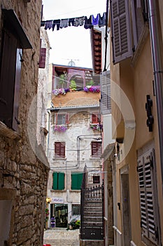 Narrow alley between old croatian houses in the picturesque old town of Rovinj, in Croatia