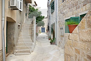 Narrow alley between stone houses, Croatia Dalmatia