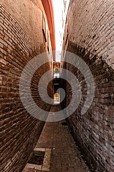 Narrow alleyway alley downtown Urban city parkway orange and red brick super wide angle