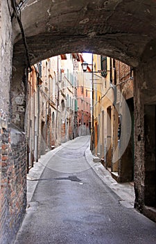 Narrow arched romantic alley in Perugia, Italy photo
