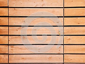Narrow brown wood plank wall texture background. Pronounced wood texture.
