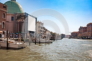 Narrow canal among old colorful brick houses in Venice, Italy