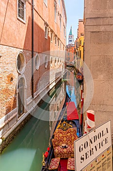 Narrow canal, St Mark tower, Gondola in Venice, Veneto, Italy