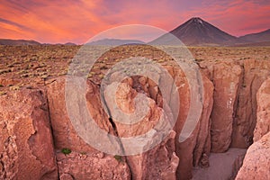 Narrow canyon and Volcan Licancabur, Atacama Desert, Chile at su photo