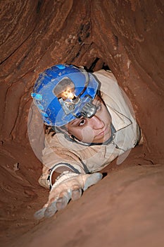 Narrow cave passage with a caver