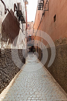 Narrow cobble stone street in Medina suburb in Marrakesh