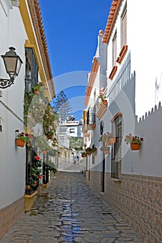 Narrow cobbled colourful back street in Estepona Spain photo