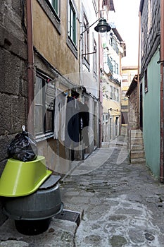 Narrow cobbled street of downtown. Authentic old town Porto, Portugal. Drying of washed laundry