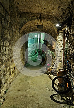 Narrow cobbled street in old town Peille at night