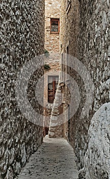 Narrow cobbled street in the old village , France.