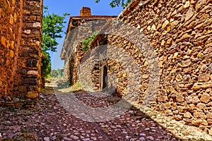 Narrow cobbled street with rustic stone houses and old and medieval atmosphere. Spain photo