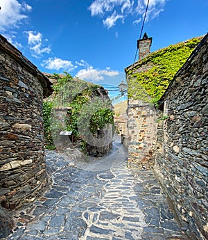 Narrow cobbled street with stone houses photo