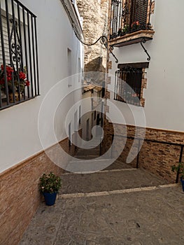 Narrow cobblestone street alley in charming white town village of Setenil de las Bodegas in Cadiz Andalusia Spain Europe