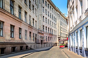 Narrow cobblestone street in old town of Riga city, Latvia. Summer sunny day