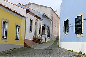 Narrow and colorful street, facades and balconies of Mafra