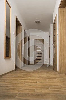 Narrow Corridor with a ceramic floor and doors in apartment