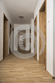 Narrow Corridor with a ceramic floor and doors in apartment