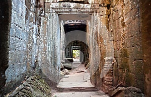 Narrow corridor in maze of the 12th century temple in Angkor, Cambodia. Historical structure