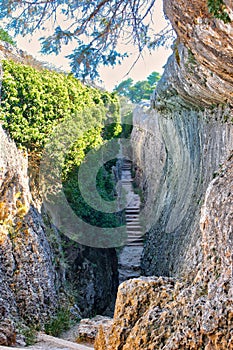 Narrow corridor between rocky walls and with stairs, called El Tobogan in La Ciudad Encantada de Cuenca, Spain photo