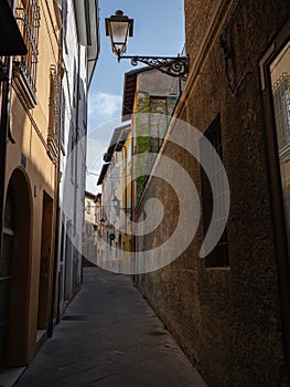 Narrow and Cramped Street with Antique Lamppost in Reggio Emilia, Italy photo