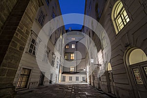 Narrow and dark medieval courtyard in the schweizerhof aisle of the Hofburg palace in Vienna, the former imperial castle residence