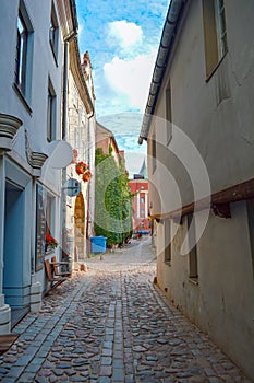 Narrow European street with cobblestone road and medieval architecture, Old Riga