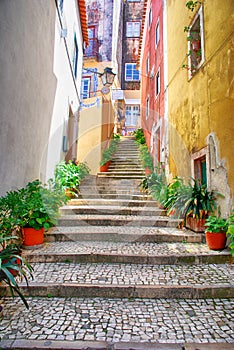 Narrow european street with cobblestone steps and old houses, Po