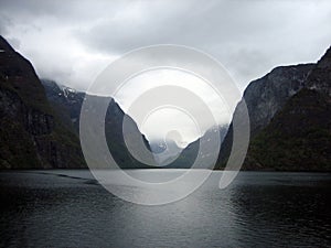 Narrow Fjord in Norway with Mountains and Clouds