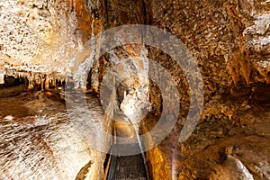 Narrow footpath in limestone cave.