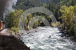 The Narrow Gauge Railway from Durango to Silverton that runs through the Rocky Mountains by the River Animas In Colorado USA